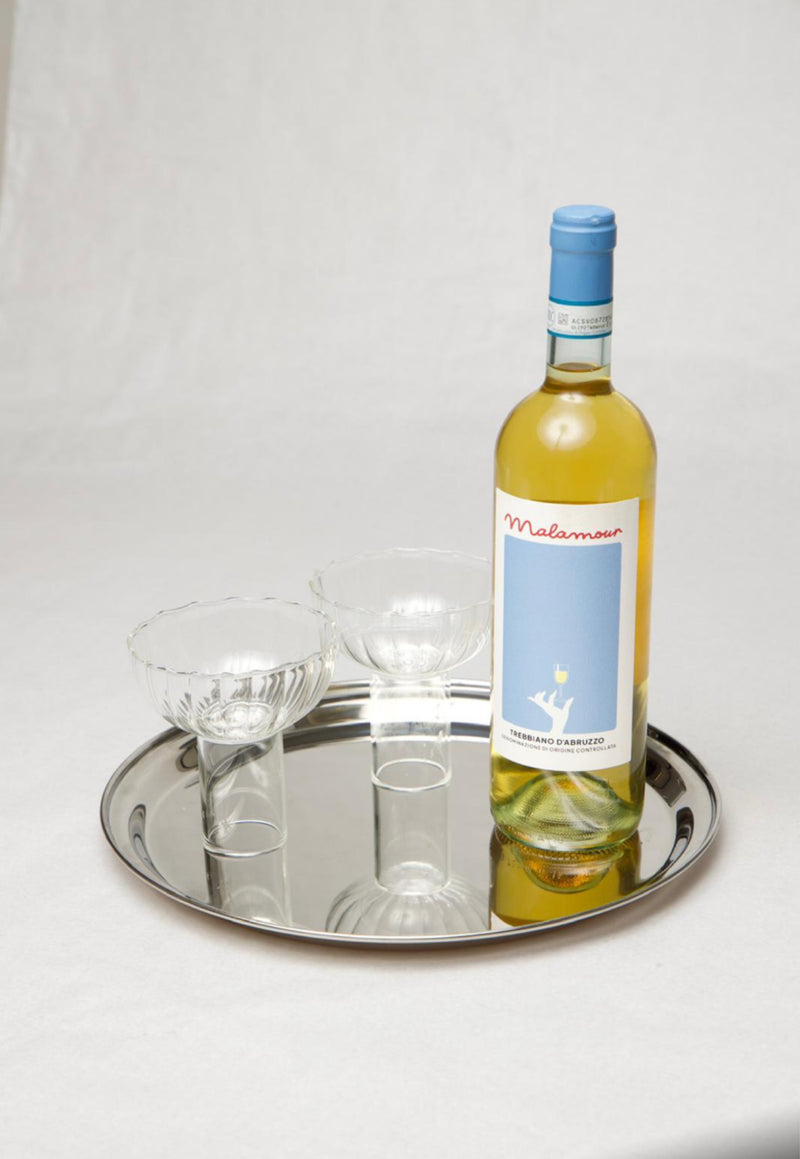 Malamour Trebbiano white wine bottle with crystal glasses on silver tray — Italian aperitivo