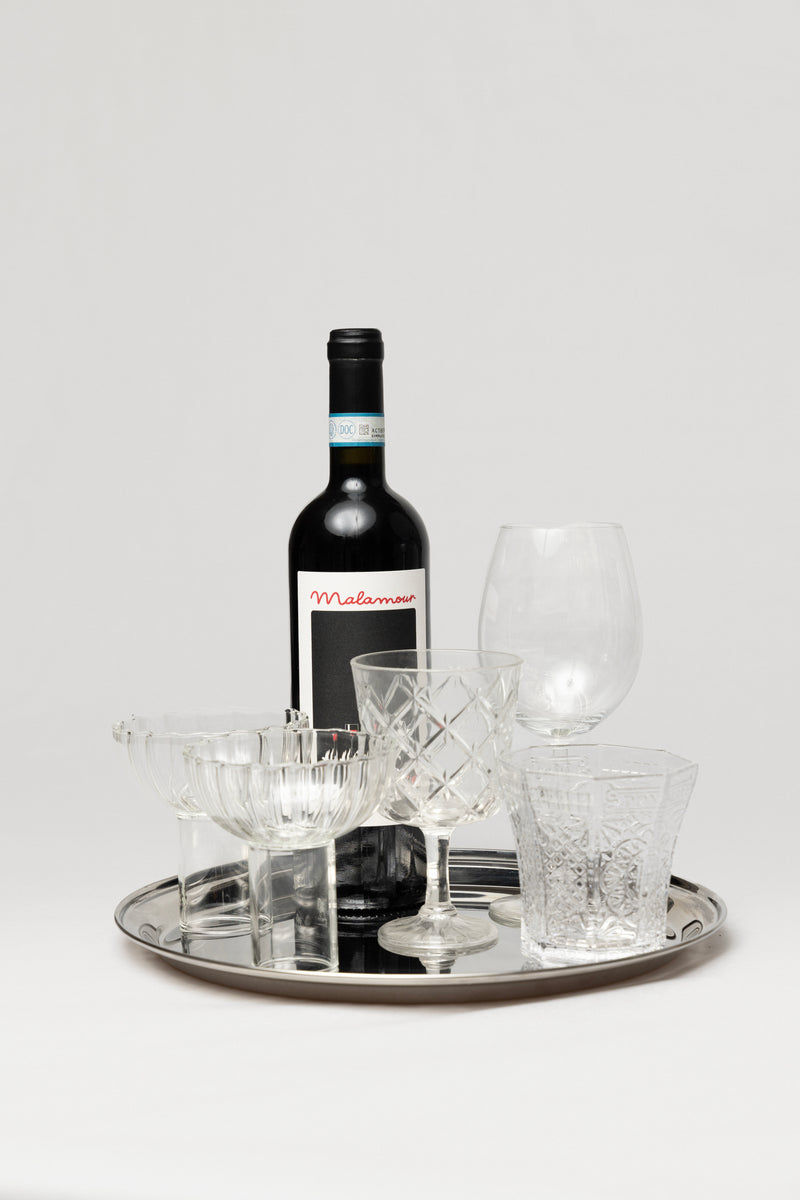 Malamour Italian wine bottle with crystal glassware — elegant Italian dinner setting