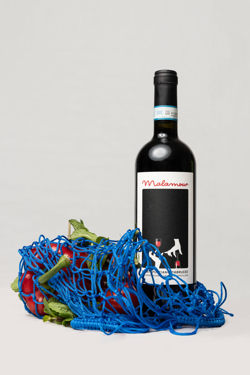 Malamour Italian wine bottle with fresh market vegetables — wine and food lifestyle